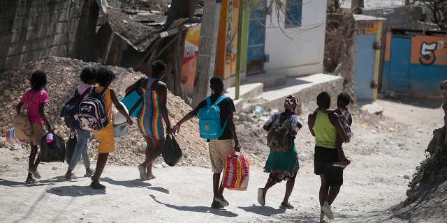 People fled their homes to avoid clashes between armed gangs in the Diegue district of Petion-Ville, Haiti, on March 23, 2023. An American couple was reportedly recently kidnaped while vacationing in Haiti.