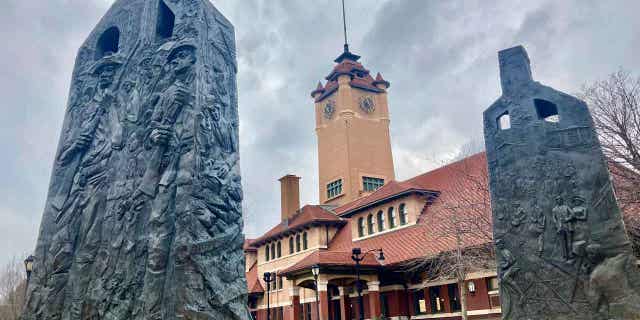 Sculptures representing charred chimneys rising from the smoldering rubble of burned-out buildings make up the Centennial memorial entitled, "Acts of Intolerance" by Preston Jackson, on March 22, 2023, in Springfield, Illinois. The Illinois Prisoner Review Board is considering a request to posthumously pardon Joe James, a man accused of murder in 1908.