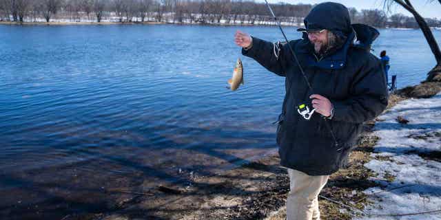 Tyler Abayare catches a fish on the Mississippi River at the Montissippi County Park near the Xcel Energy nuclear power plant in Monticello on March 24, 2023.