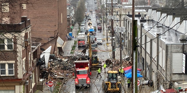 Emergency responders and heavy equipment are seen at the site of a deadly explosion at a chocolate factory in West Reading, Pennsylvania, Saturday, March 25.