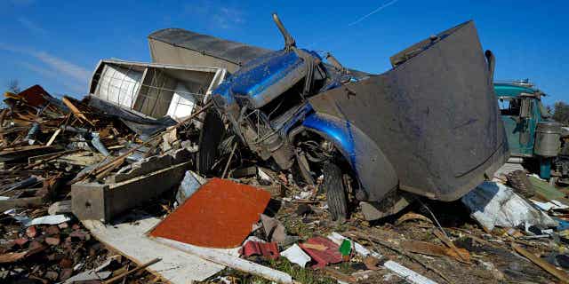 Two semis are seen bunched up on March 26, 2023, in Rolling Fork, Mississippi, after they were moved by a tornado two days earlier. Emergency officials in Mississippi say at least 25 people died during the tornado.