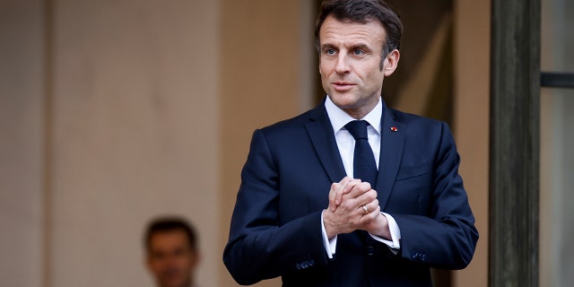 French President Emmanuel Macron talks to the media as he awaits President of Costa Rica Rodrigo Chaves Robles for a meeting at the Élysée Palace in Paris March 24, 2023.