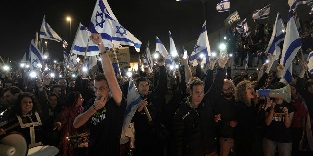 Israelis opposed to Prime Minister Benjamin Netanyahu's judicial overhaul plan protest outside of the Knesset, the country's parliament, after the Israeli leader fired his defense minister, in Jerusalem, Monday, March 27, 2023.