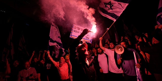 Israelis opposed to Prime Minister Benjamin Netanyahu's judicial reform plan block a highway during a protest after the Israeli leader fired his defense minister, in Tel Aviv, Israel, on Monday, March 27, 2023. 