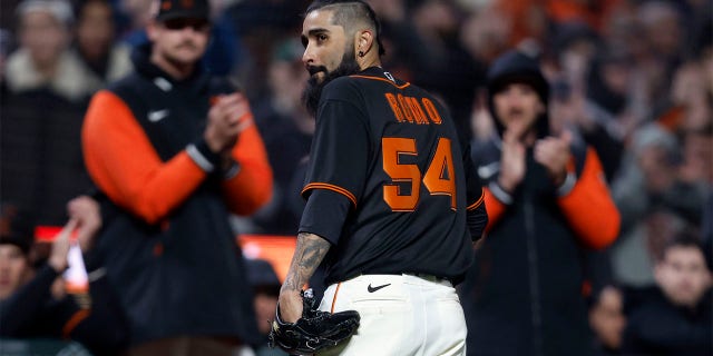 San Francisco Giants pitcher Sergio Romo (54) walks back to the dugout after being removed during the seventh inning of a spring training baseball game against the Oakland Athletics in San Francisco, Monday, March 27, 2023.