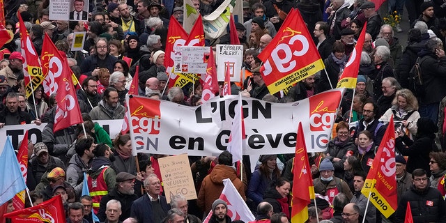People march during a demonstration in Paris, Tuesday, March 28, 2023. 