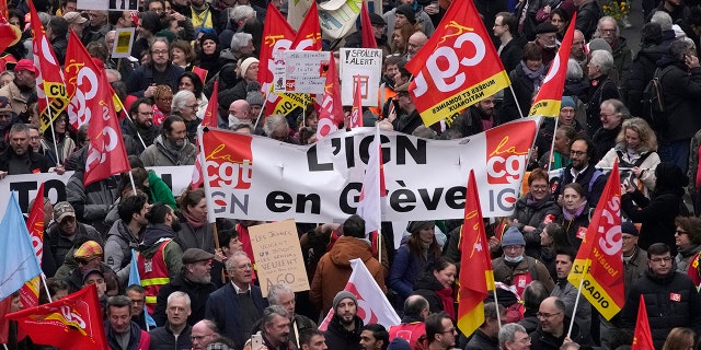 People march during a demonstration Tuesday, March 28, 2023, in Paris. 