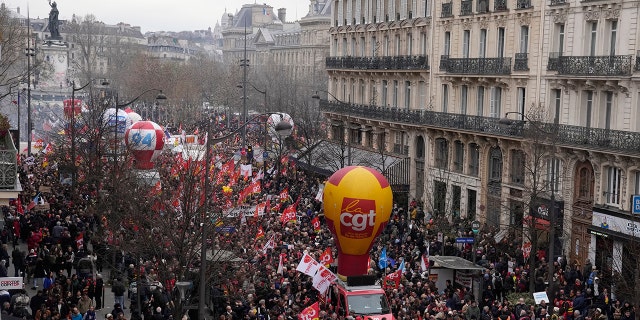 People march during a demonstration Tuesday, March 28, 2023 in Paris. Protests are taking place in France on Tuesday.
