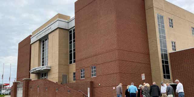 A group of people gather before a State Board of Elections meeting on March 28, 2023, at the Surry County Courthouse in Dobson, North Carolina. The state election board removed two local officials who refused to certify their county's election results.