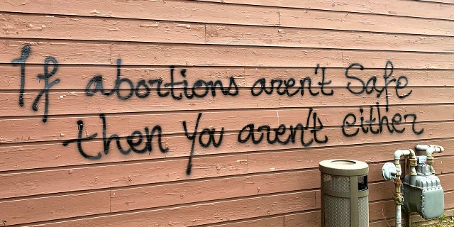 Threatening graffiti is seen on the exterior of Wisconsin Family Action offices in Madison, Wisconsin, May 8, 2022. Hridindu Sankar Roychowdhury was charged in the attack ahead of the U.S. Supreme Court's decision to overturn Roe v. Wade.