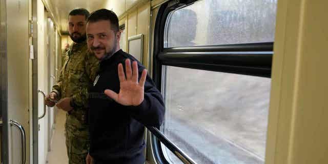 Ukrainian President Volodymyr Zelensky waves goodbye after an interview on a train traveling to Kiev, Ukraine, on March 28, 2023. In the interview, Zelensky claimed to have invited Chinese leader Xi Jinping to visit Ukraine.