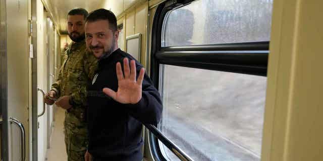 Ukrainian President Volodymyr Zelenskyy waves goodbye after an interview on a train traveling to Kyiv, Ukraine, on March 28, 2023. In the interview Zelenskyy claims he invited Chinese leader Xi Jinping to visit Ukraine.