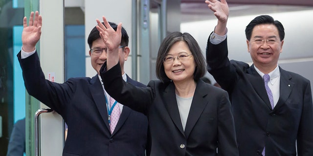 Taiwan's Presidential office secretary general Lin Chia-lung, left, President Tsai Ing-wen, center, and Foreign Minister Joseph Wu depart on an overseas trip at Taoyuan International Airport in Taipei, Taiwan, Wednesday, March 29, 2023.