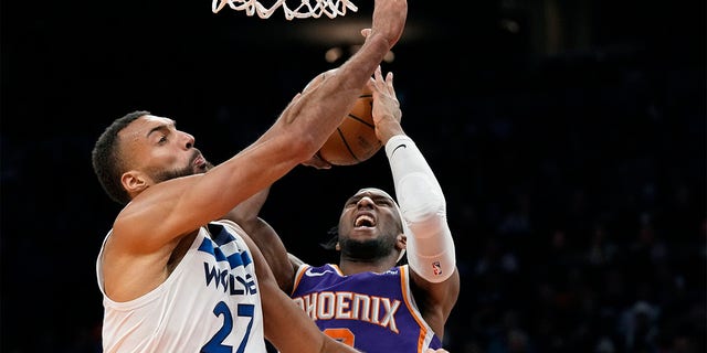 Suns forward Josh Okogie is fouled as he takes a shot against Minnesota Timberwolves center Rudy Gobert on Wednesday, March 29, 2023, in Phoenix.  The Suns won 107-100.