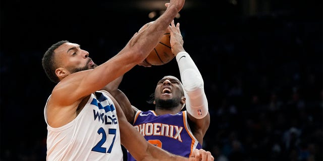 Suns forward Josh Okogie is fouled as he takes a shot against Minnesota Timberwolves center Rudy Gobert on Wednesday, March 29, 2023, in Phoenix.  The Suns won 107-100.