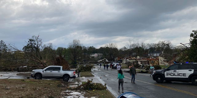 Residents mill about after severe storm swept through Little Rock, Ark., Friday, March 31, 2023.