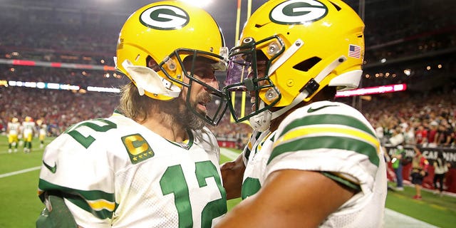 Aaron Rodgers, #12 of the Green Bay Packers, congratulates Rasul Douglas, #29, following an interception during the fourth quarter of a game against the Arizona Cardinals at State Farm Stadium on October 28, 2021 in Glendale, Arizona.