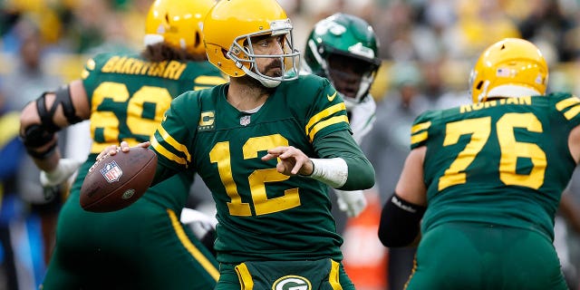 Aaron Rodgers #12 of the Green Bay Packers moves back to pass against the New York Jets at Lambeau Field on October 16, 2022 in Green Bay, Wisconsin.