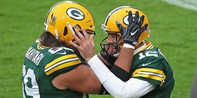 Aaron Rodgers of the Packers celebrates a touchdown run against the Jacksonville Jaguars with David Bakhtiari at Lambeau Field on Nov. 15, 2020, in Green Bay, Wisconsin.