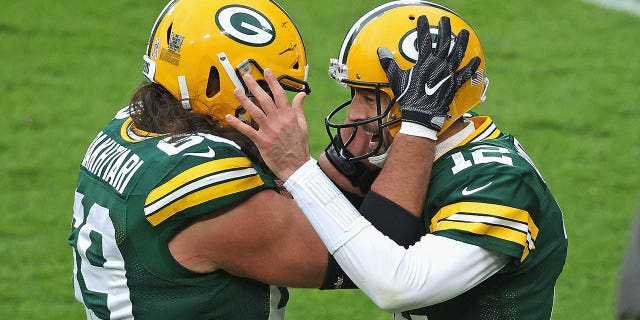 Aaron Rodgers of the Packers celebrates a touchdown run against the Jacksonville Jaguars with David Bakhtiari at Lambeau Field on Nov. 15, 2020, in Green Bay, Wisconsin.