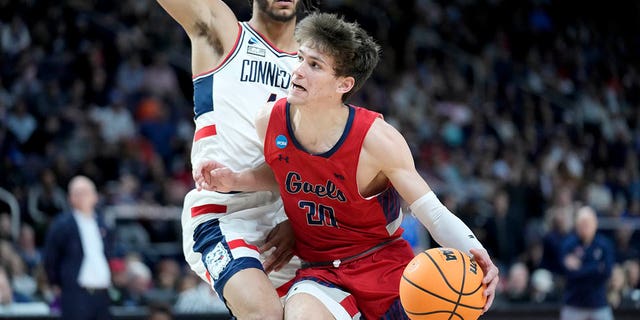 St. Mary's Aidan Mahaney (20) drives against Connecticut's Nahiem Alleyne, left, in the first half of a second-round college basketball game in the NCAA Tournament, Sunday, March 19, 2023, in Albany, N.Y. 