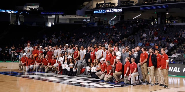 Alabama Crimson Tide players and coaches pose for a picture at a practice ahead of the first round of the NCAA men’s basketball tournament at Legacy Arena at the BJCC March 15, 2023, in Birmingham, Ala.