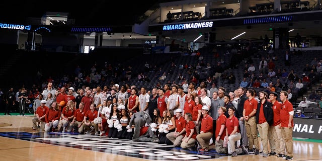 Alabama Crimson Tide players and coaches pose for a picture at a practice ahead of the first round of the NCAA men’s basketball tournament at Legacy Arena at the BJCC March 15, 2023, in Birmingham, Ala.