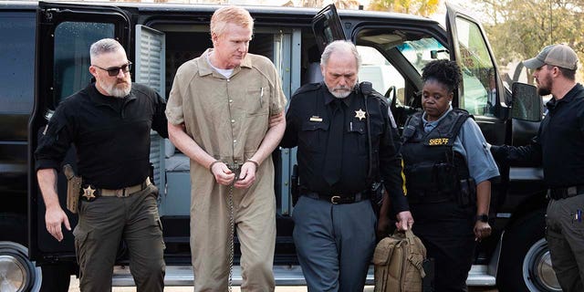 Alex Murdaugh attends his sentencing wearing a tan jumpsuit and handcuffs.