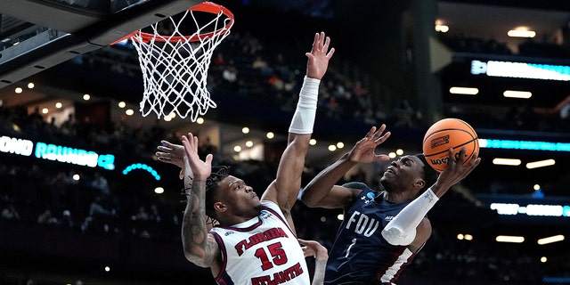 Joe Munden Jr., #1 of the Fairleigh Dickinson Knights, shoots the ball against Alijah Martin, #15 of the Florida Atlantic Owls, during the second half in the second round game of the NCAA Men's Basketball Tournament at Nationwide Arena on March 19, 2023 in Columbus, Ohio.