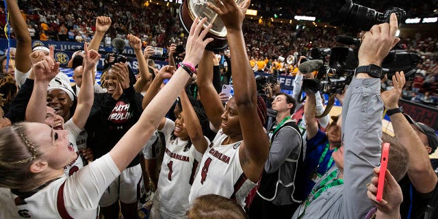 South Carolina's Aliyah Boston holds up the championship trophy after defeating Tennessee 74-58 to win the championship game of the Southeastern Conference Tournament in Greenville, S.C., March 5, 2023.