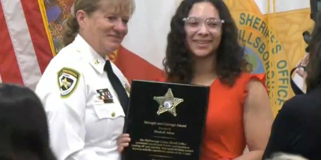 Nashali Alma, 24, accepts the first-ever "Strength and Courage Award" offered by the Hillsborough County Sheriff's Office.