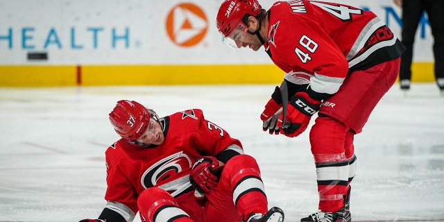 Andrei Svechnikov #37 of the Carolina Hurricanes reacts after suffering an injury during the second period against the Philadelphia Flyers at PNC Arena on March 09, 2023 in Raleigh, North Carolina.