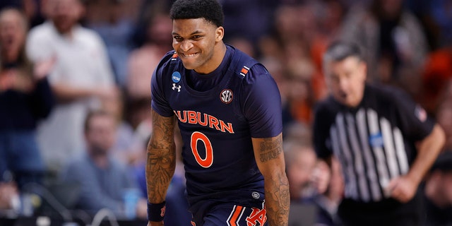 KD Johnson #0 of the Auburn Tigers reacts after a three point basket in the second half against the Iowa Hawkeyes in the first round of the NCAA Men's Basketball Tournament at Legacy Arena at BJCC on March 16, 2023 in Birmingham, Alabama.