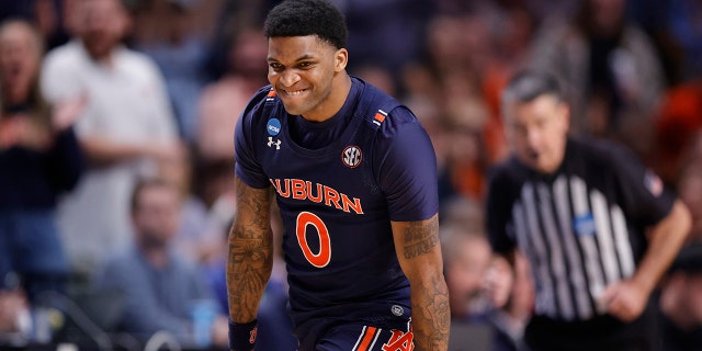 K.D. Johnson #0 of the Auburn Tigers reacts after a three point basket during the second half against the Iowa Hawkeyes in the first round of the NCAA Men's Basketball Tournament at Legacy Arena at the BJCC on March 16, 2023 in Birmingham, Alabama.