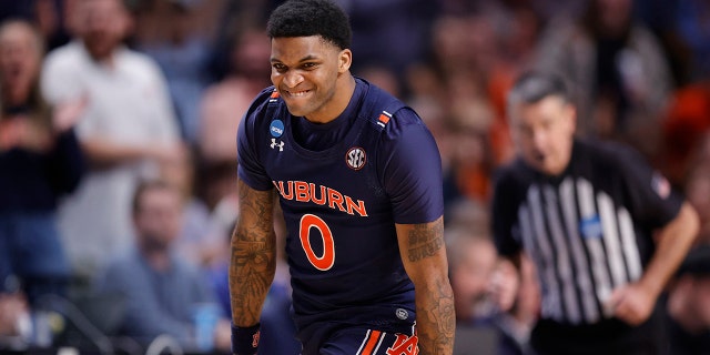 KD Johnson #0 of the Auburn Tigers reacts after a three point basket during the second half against the Iowa Hawkeyes in the first round of the NCAA Men's Basketball Tournament at Legacy Arena at the BJCC on March 16, 2023 in Birmingham , Alabama.