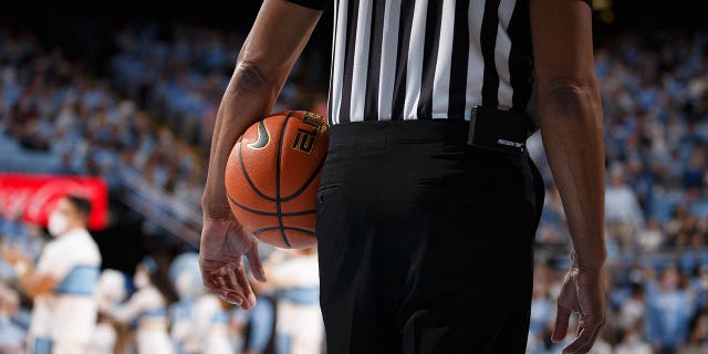 A referee holds a ball during a game between the North Carolina Tar Heels and the Elon Phoenix at Dean E. Smith Center on Dec. 11, 2021, in Chapel Hill, North Carolina.