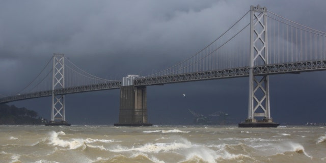 High winds create large waves along The Embarcadero near Pier 14 between Mission Street and Howard Street in San Francisco on March 21, 2023. 