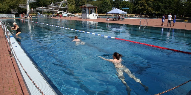 Swimmers do their laps in the pool at the Pankow summer pool in Germany, in August 2022. 