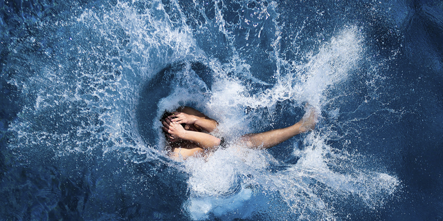 A boy jumps into the water at the open air public pool in Berlin, Germany, in 2014. Women in the city will soon be able to go topless at its public pools, officials say. 