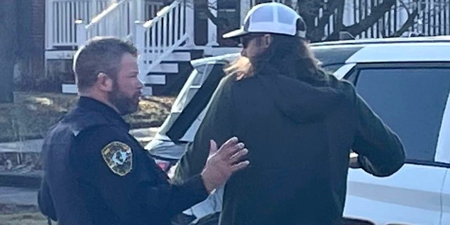 Tim Bliefnick speaks with a deputy as investigators search his home on Wednesday, March 1, 2023. QPD Officer Gabe VanderBol checks Tim Bliefnick to see if he is armed before putting him in the squad car. Bliefnick was not arrested at that time and was cooperative.