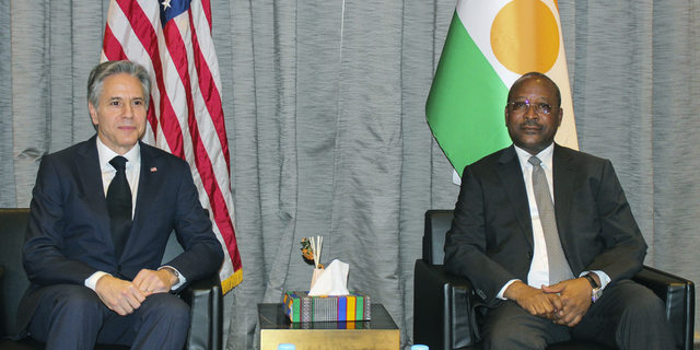 US Secretary of State Antony Blinken, left, sits with Nigerian Foreign Minister Hasumi Massoudou at Diori Hamane International Airport, in Niamey, Niger, on Thursday, March 16. The meeting took place days before Woodky's release was announced.