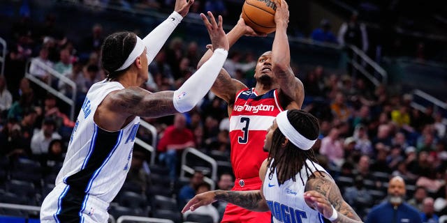 Mar 21, 2023; Orlando, Florida, USA; Washington Wizards guard Bradley Beal (3) shoots over Orlando Magic forward Paolo Banchero (5) during the second half at Amway Center.