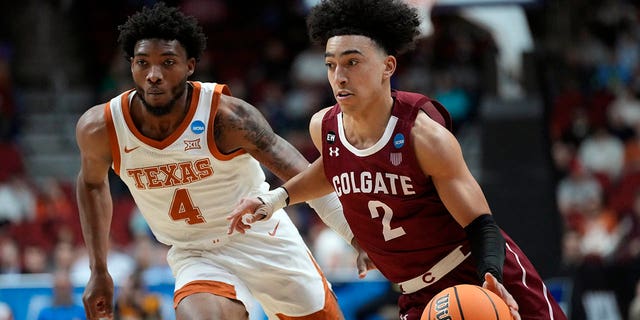 Colgate guard Braeden Smith (2) drives past Texas guard Tyrese Hunter (4) in the first half of a first-round college basketball game in the NCAA Tournament, Thursday, March 16, 2023, in Des Moines, Iowa. 