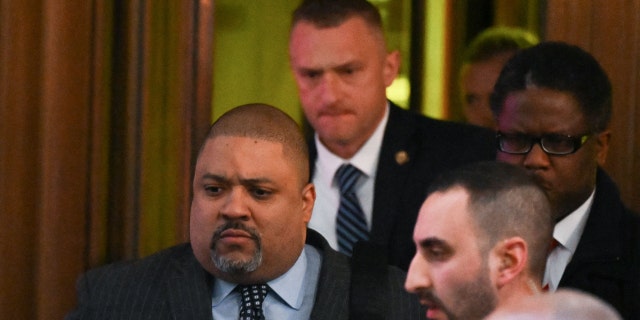 Manhattan District Attorney Alvin Bragg (L) leaves his office in New York on March 30, 2023. - Manhattan district attorney Alvin Bragg became the first prosecutor in US history to charge a former or sitting president when he filed his indictment against Donald Trump. The 49-year-old Democrat is no stranger to landmark moments: he is the first Black Manhattan DA, winning election to the post in November 2021. 