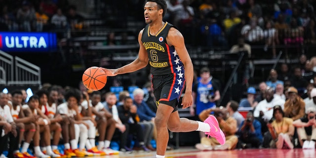 Bronny James of the West team dribbles the ball during the 2023 McDonald's High School Boys All-American Game at Toyota Center March 28, 2023, in Houston.