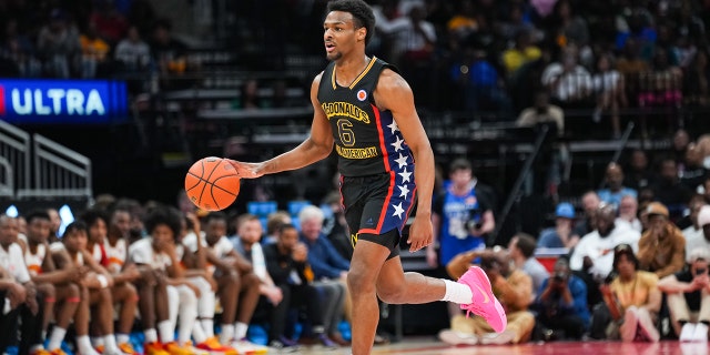 Bronny James of the West team dribbles the ball during the 2023 McDonald's High School Boys All-American Game at Toyota Center March 28, 2023, in Houston.