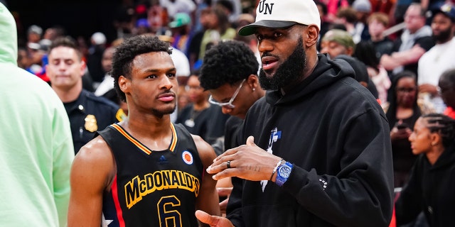 LeBron James talks with son, Bronny, on court