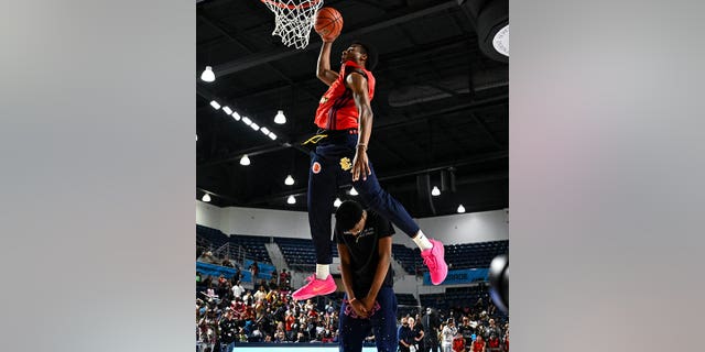 McDonald's All American West guard Bronny James, #6, dunks the ball over Bryce James during the Powerade Jam Fest at Delmar Athletic Complex in Houston March 27, 2023.