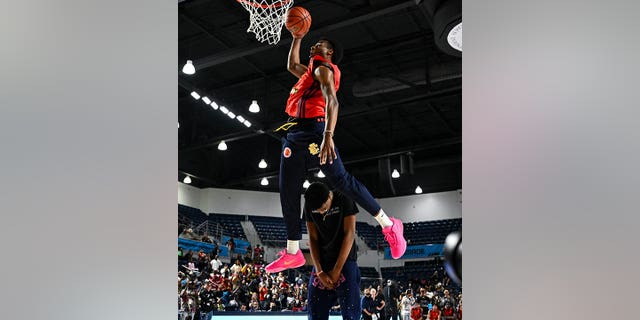 McDonald's All American West guard Bruni James, #6, dunks the ball over Bryce James during the Powerade Jam Fest at the Delmar Athletic Complex in Houston on March 27, 2023.