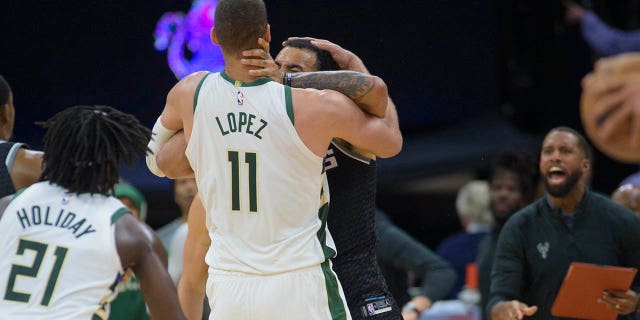 Milwaukee Bucks center Brook Lopez, #11, and Sacramento Kings forward Trey Lyles scuffle in the final seconds of the second half of an NBA basketball game in Sacramento, California, Monday, March 13, 2023.